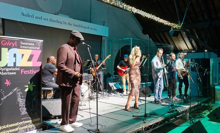 A band playing on a stage at the Swansea Jazz Festival